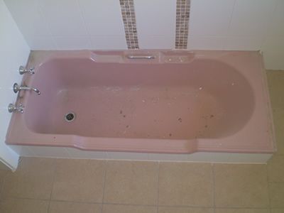 Before: a stained built-in bath