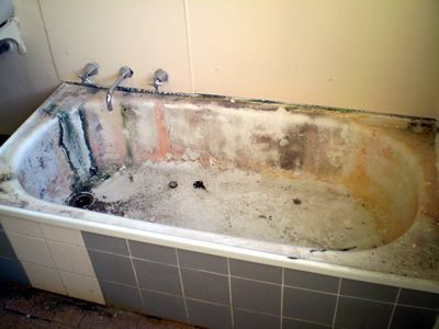 Before: a worn enamel bath